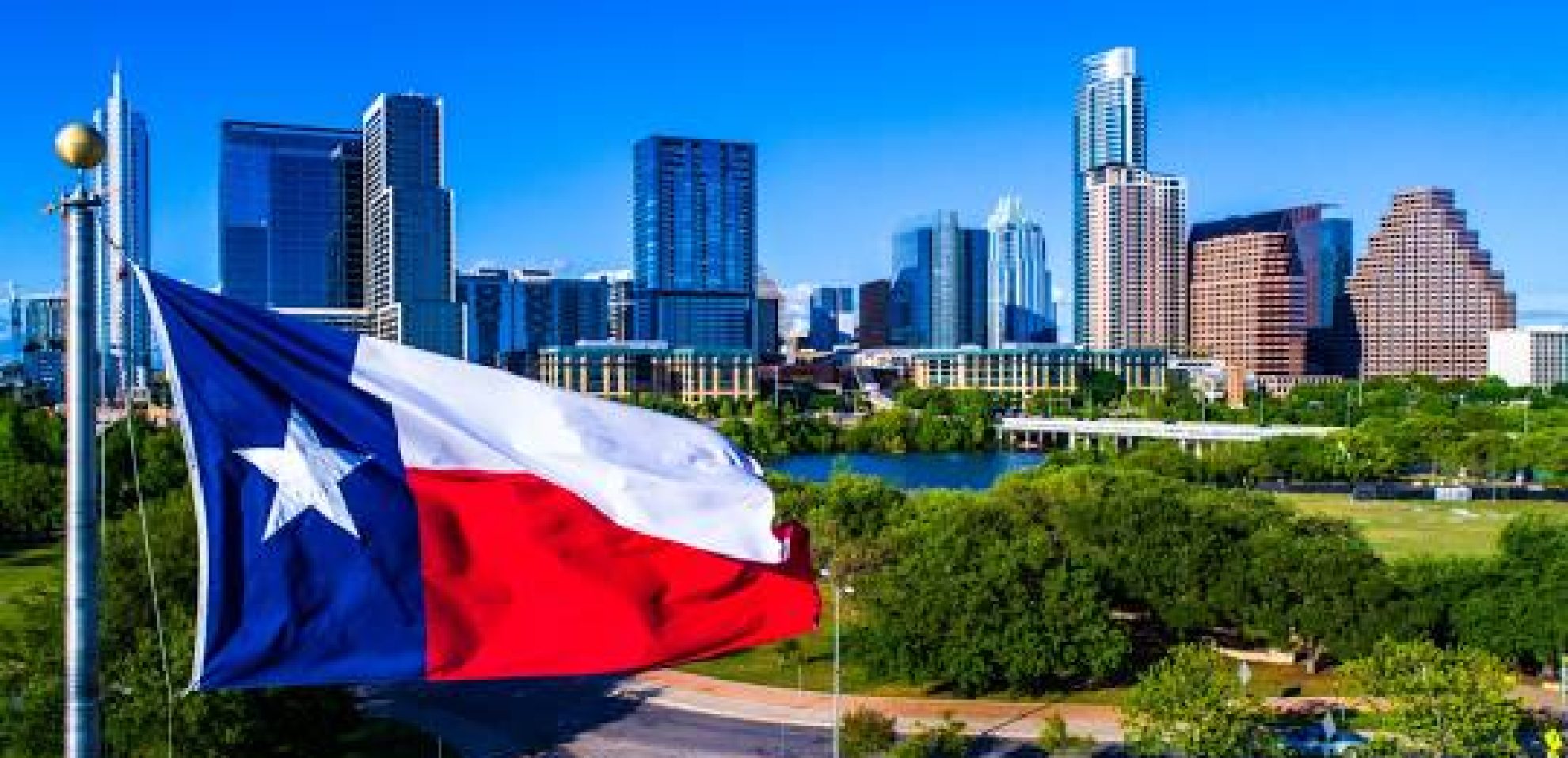 Photo depicting Texas State Flag and city skyline